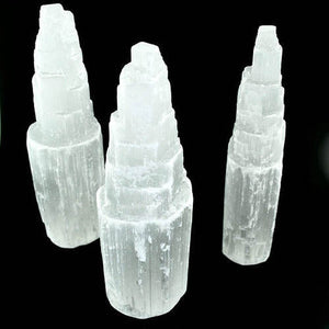 7" Selenite Cleansing Towers  A protective stone, Selenite shields a person or space from outside influences. Selenite is a crystallized form of Gypsum, which is used for good luck and protection. The powerful vibration of Selenite can clear, open, and activate the Crown and Higher Chakras and is excellent for all types of spiritual work. It's also excellent for clearing your aura and other crystals.  By Buddha Gear